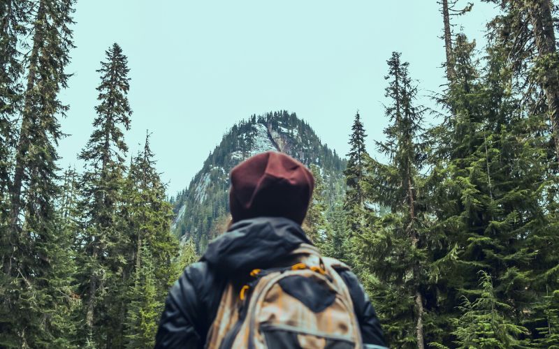 Hiker looking up at mountain