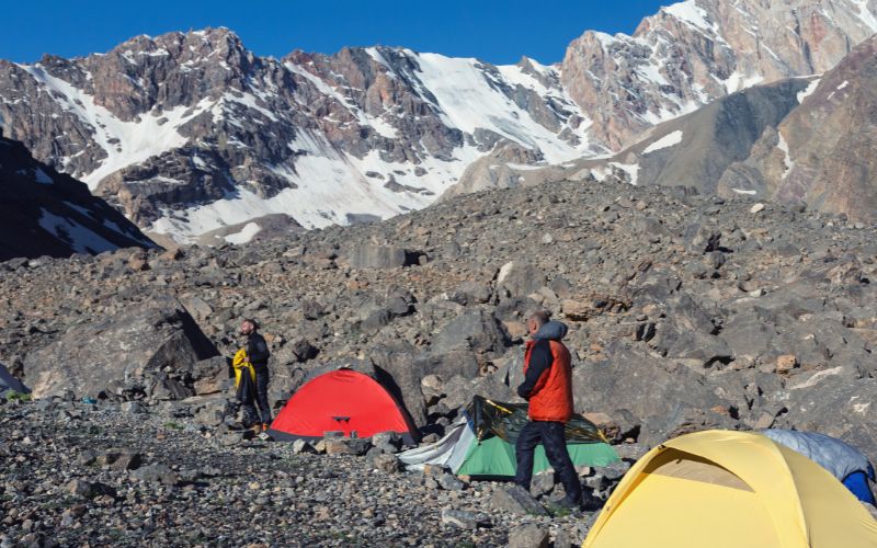 Climbers with tents and bivy pitched in mountains