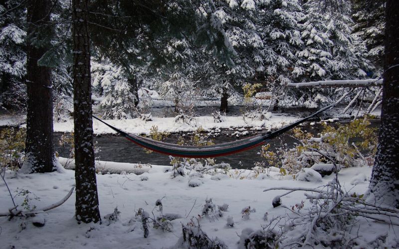 Hammock hung in wintery snowy river scene