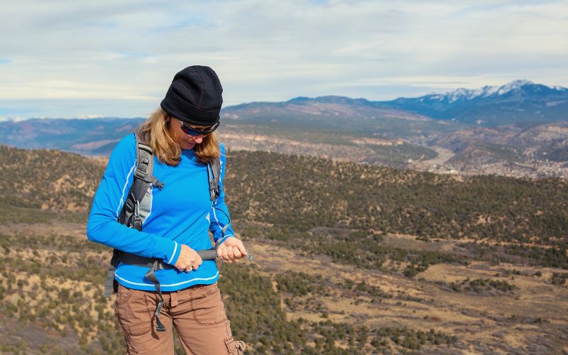 Woman adjusting straps on her backpack