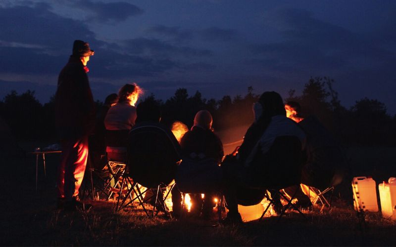 Campers around a campfire at nighttime