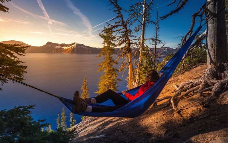 Woman in hammock looking out over Lake Oregon