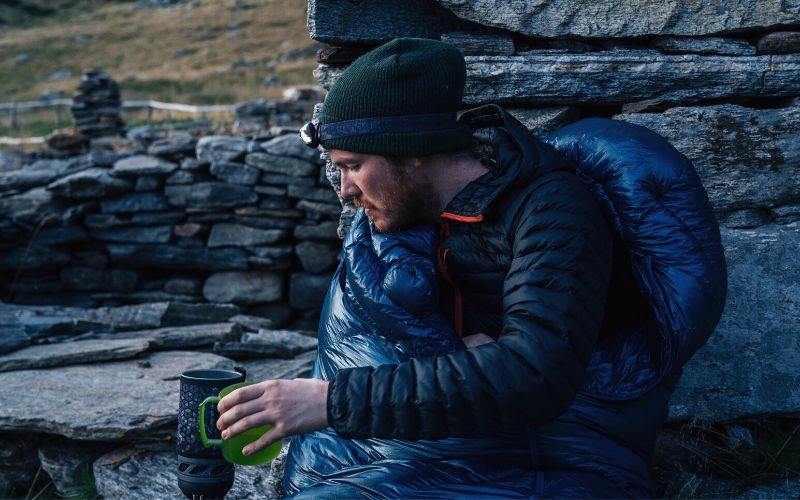 Camper making hot drink using a Jetboil stove