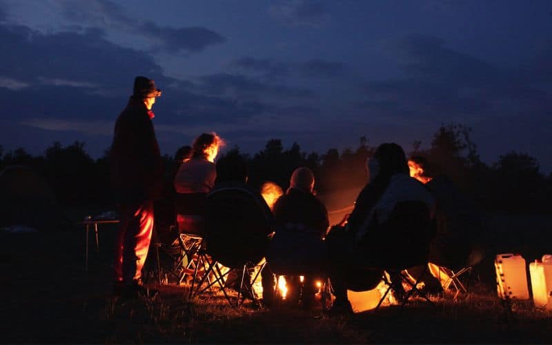 Campers around campfire in the dark