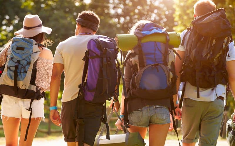 Campers with backpacks walking away