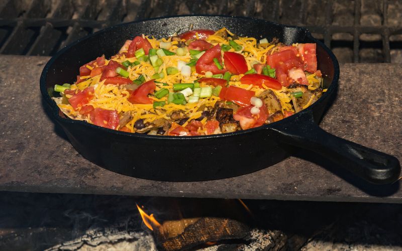 Campfire cooked nachos in cast iron skillet