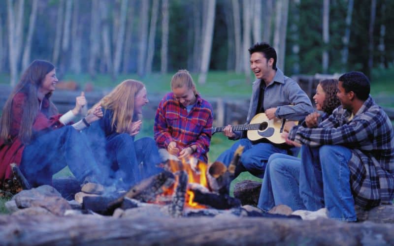 Campers laughing around the campfire