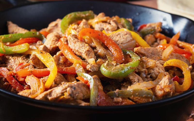 Chicken Fajitas cooked in a cast iron skillet