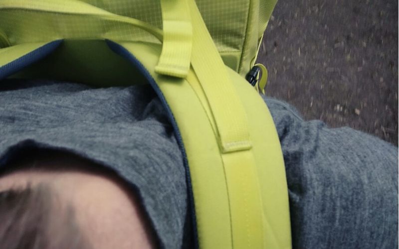 Close up of backpack shoulder straps and load lifters worn by a hiker