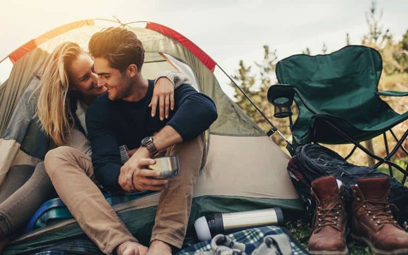 Couple laughing inside their tent