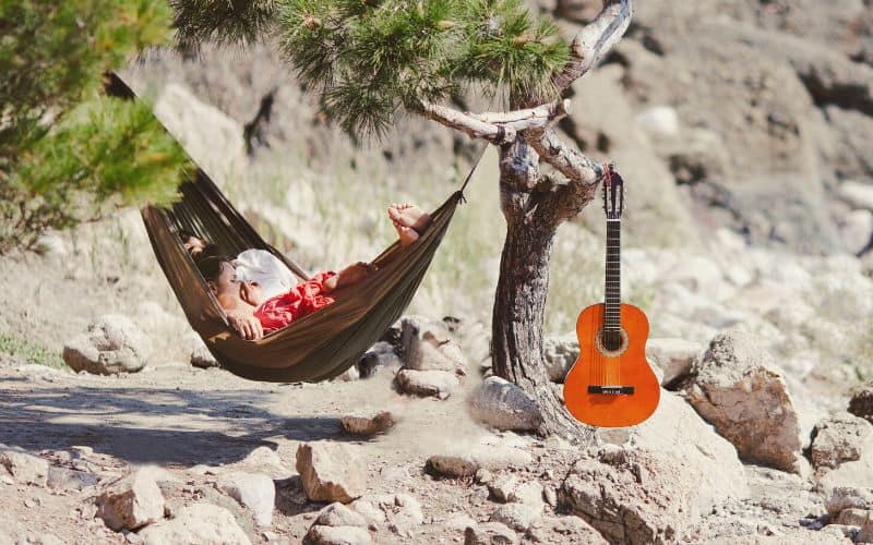 Couple napping in hammock attached to a tree