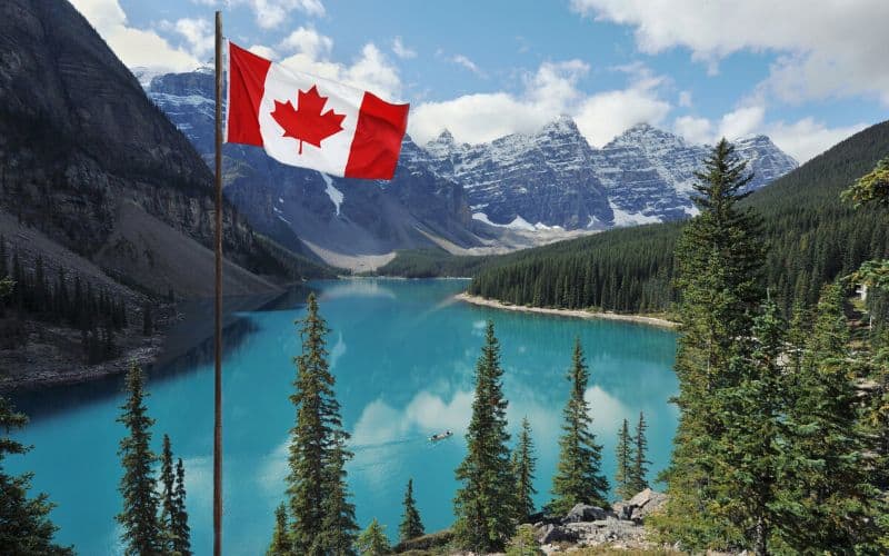 The Canadian flag against the Rocky Mountains in Banff NP