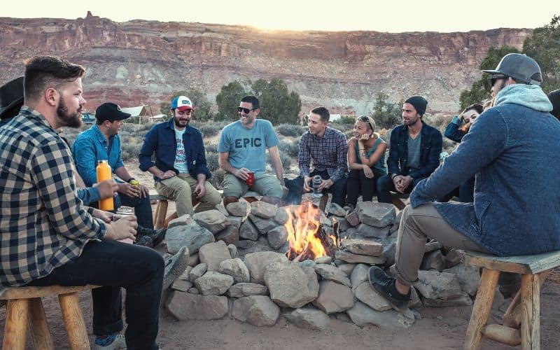 Group of friends sitting around a bonfire playing Werewolf