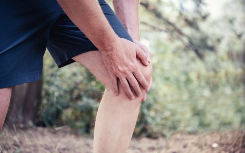 Hiker holding swollen knee cap