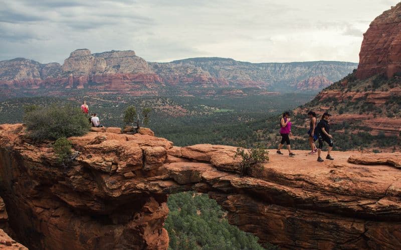 Hikers walking across Devils Bridge Sedona