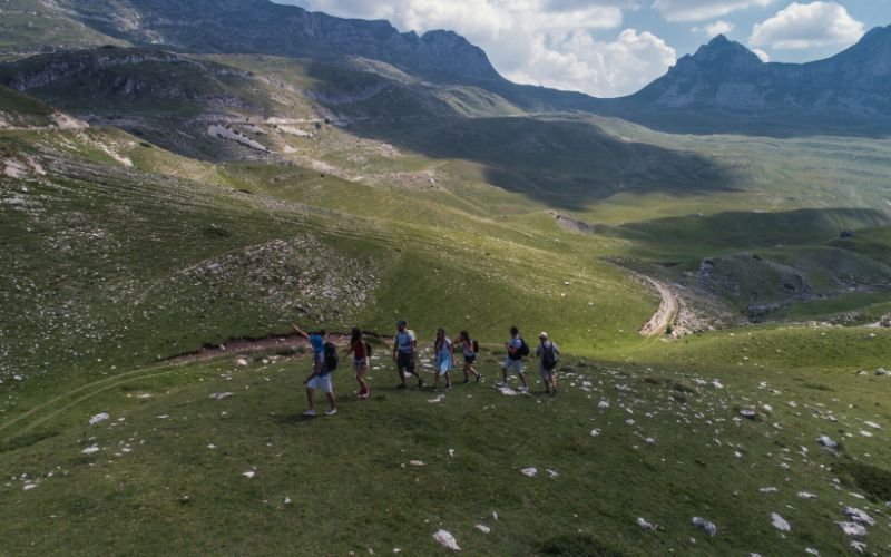 Hiking guide leading a tour group through the mountains