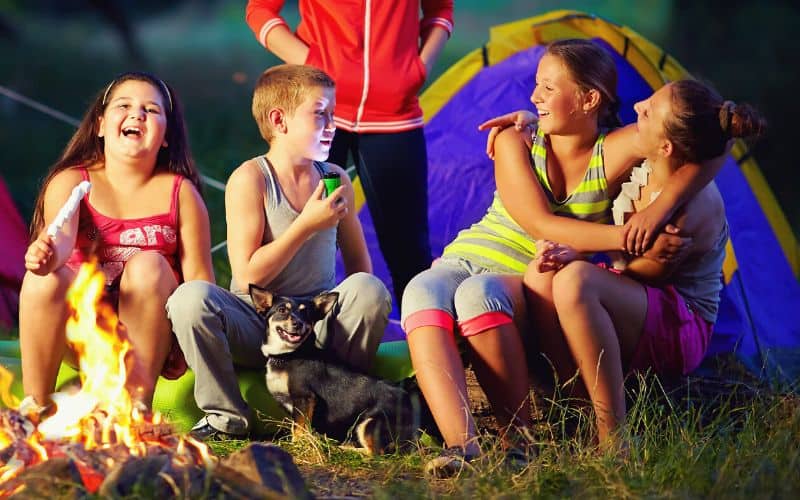 Kids telling stories round a campfire