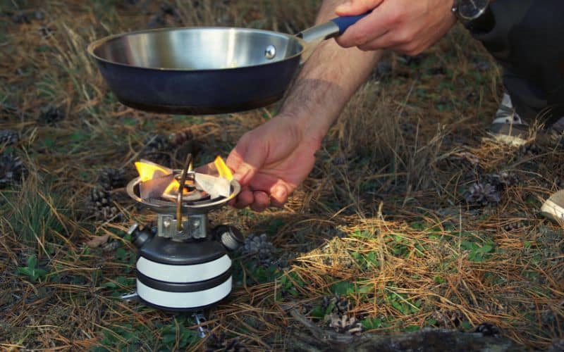 Man lighting a gas camping stove