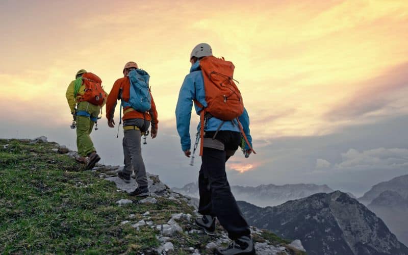 Mountaineers walking along mountain ridge