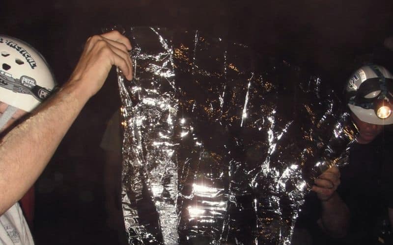 Rescuers with a foil balnket