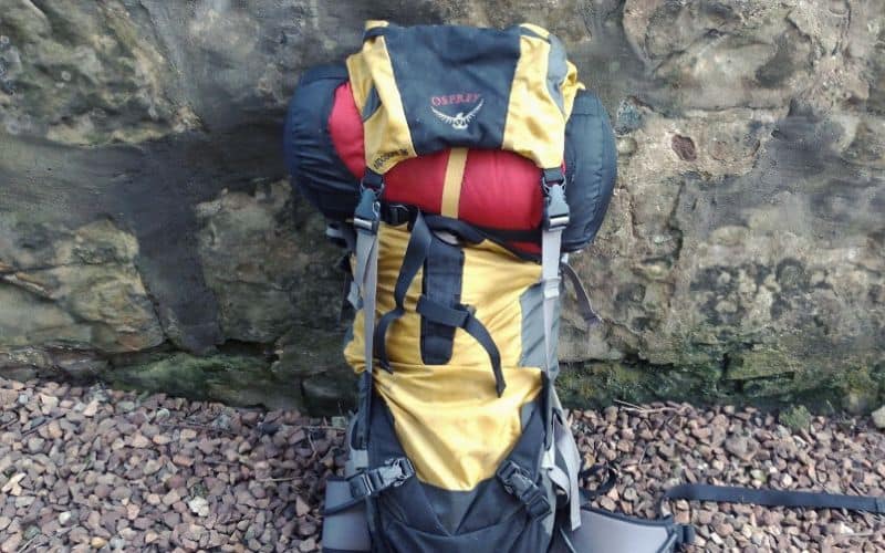 Sleeping bag attached to backpack under backpack hood/lid