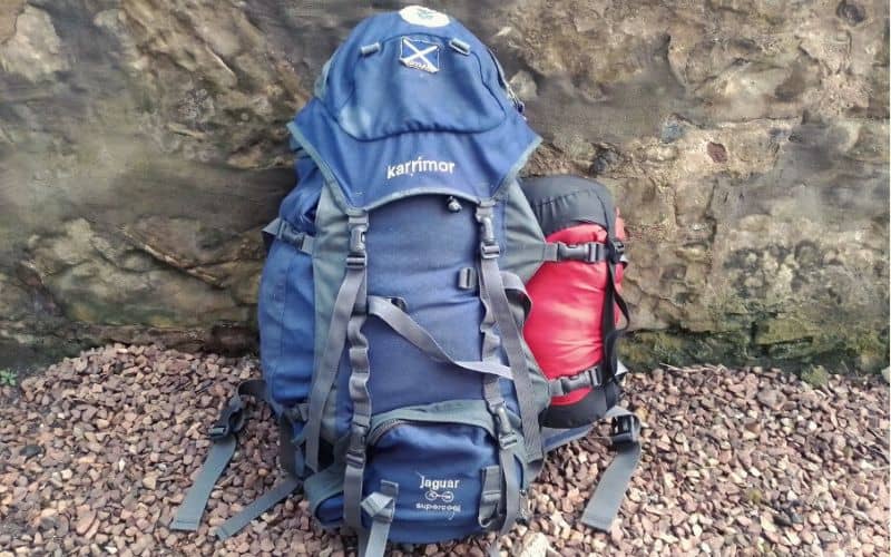 Sleeping bag attached to backpack with backpack gear loops