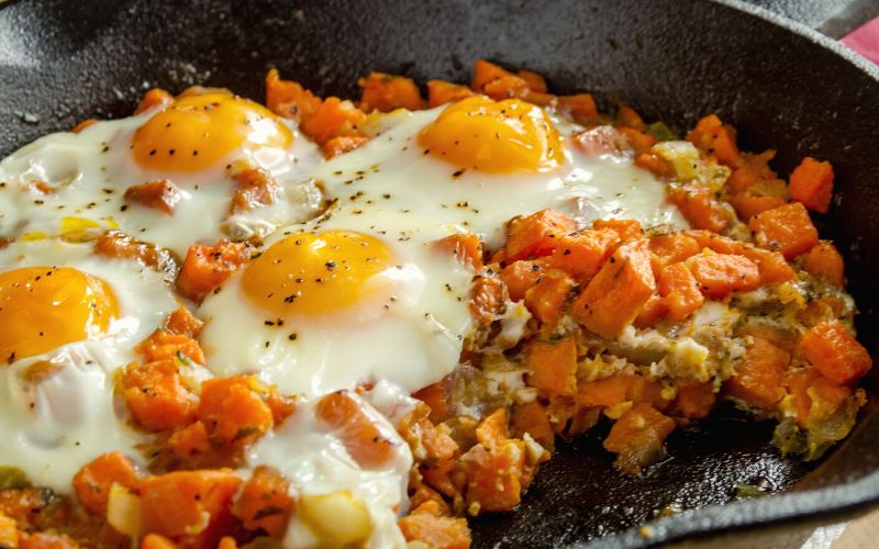 Steak and Sweet Potato Hash with fried eggs on top