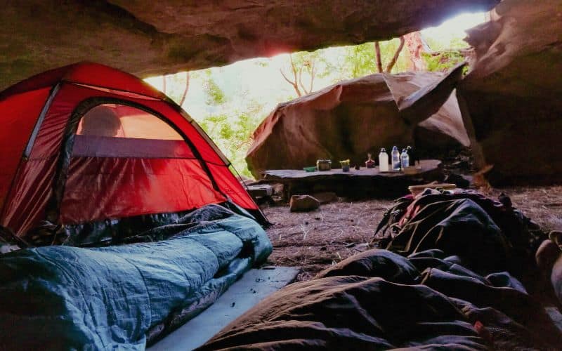 Tents pitched under rock overhang