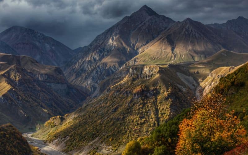 View of mountains with grey clouds above