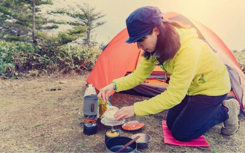 Woman cooking at her campsite