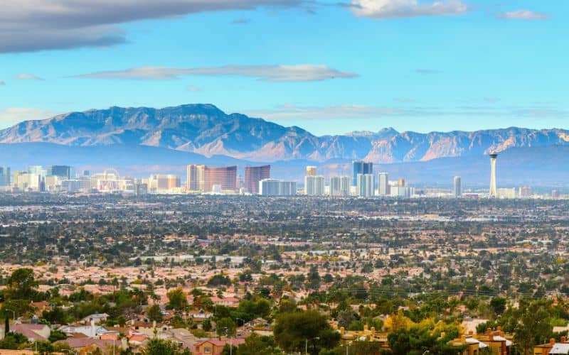 View of Las Vegas skyline with mountains towering behind it