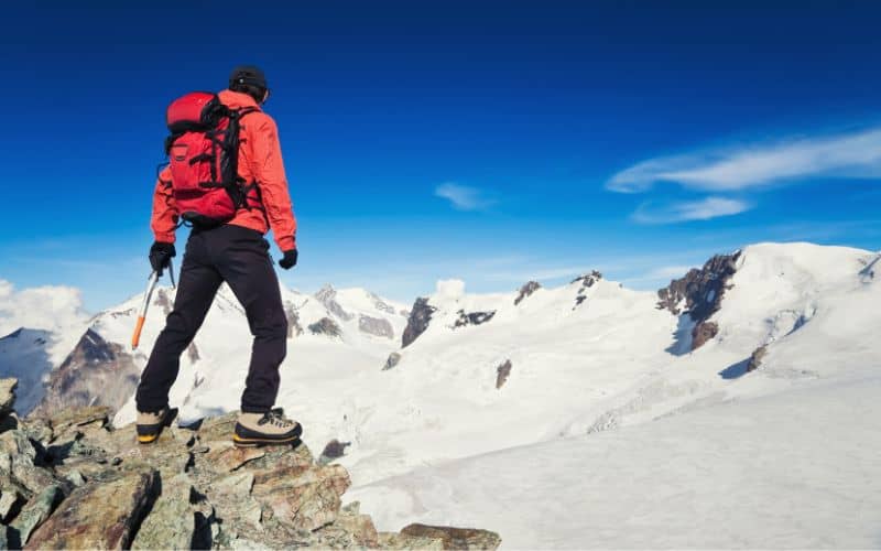 Man hiking with ice axe in high altitudes