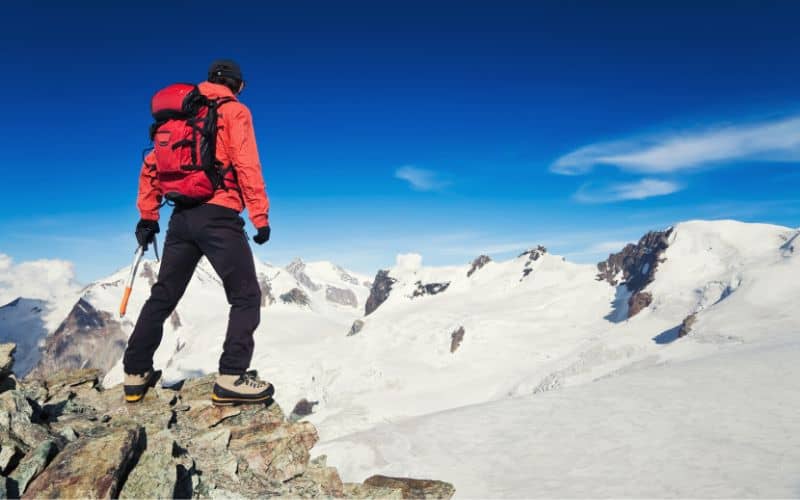 Man hiking with ice axe in high altitudes