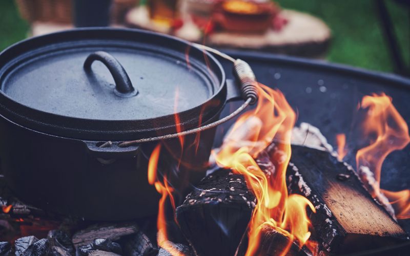 Cast iron dutch oven over a campfire