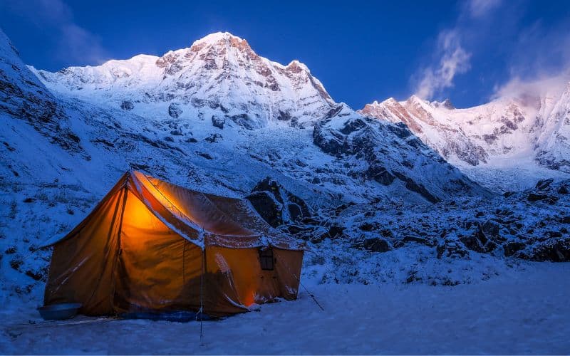 Canvas cabin tent pitched in the snowy mountains