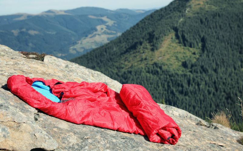 Sleeping bag on a ledge in front of mountains