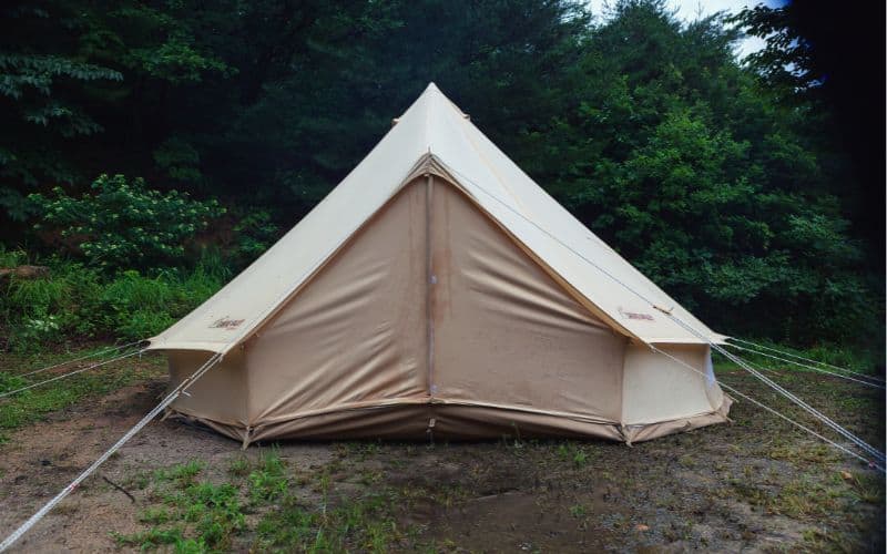 A canvas bell tent pitched in the rain 