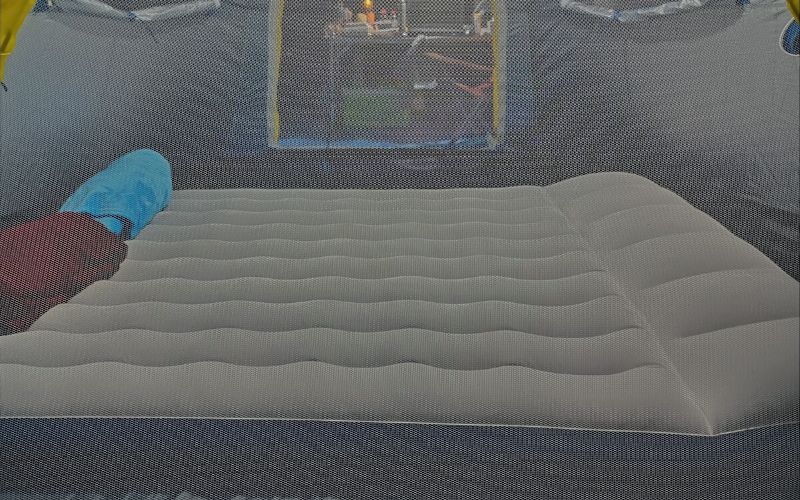 Air mattress set up inside tent through a mosquito net