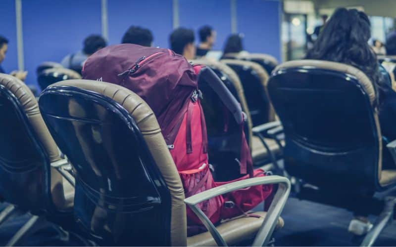 Backpack sitting on chair at an airport