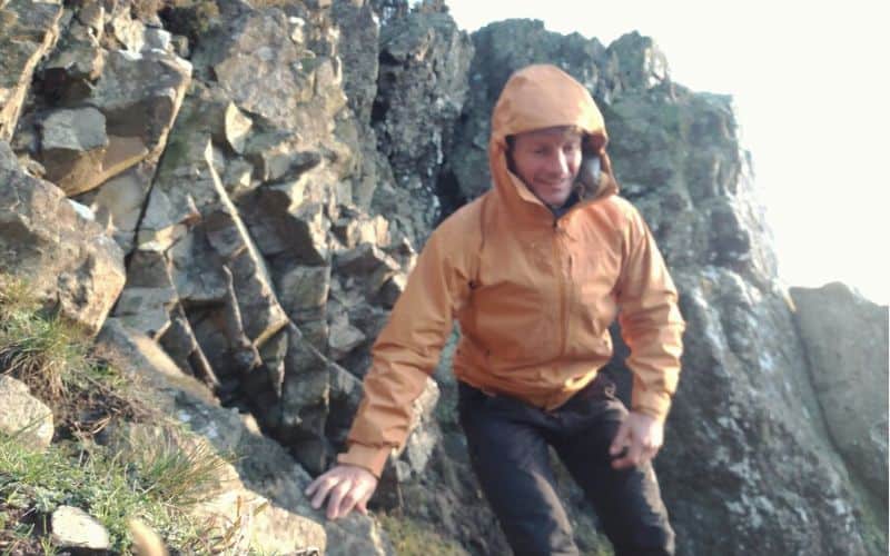 Hiker scrambling wearing Patagonia Dual Aspect Jacket