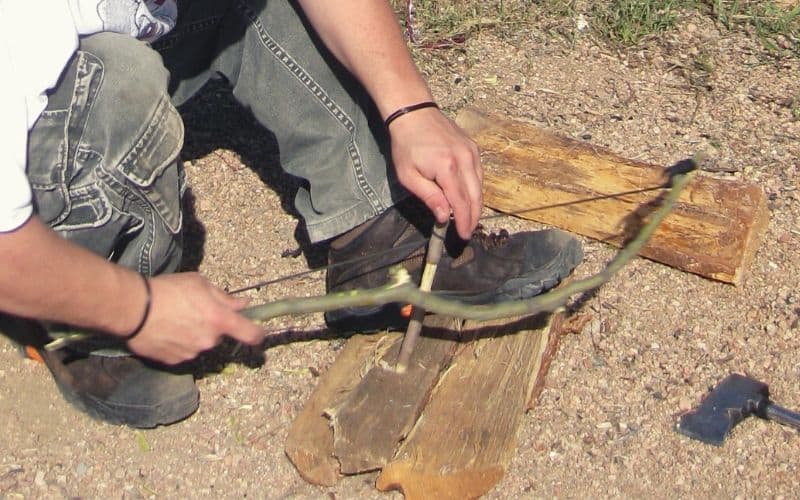 Man using a fire bow drill
