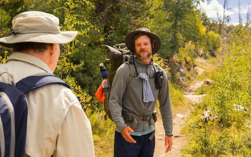 Two hikers talking to each other on the trail