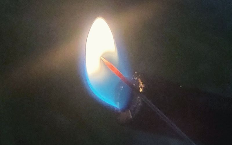 Heating up a needle with a flame