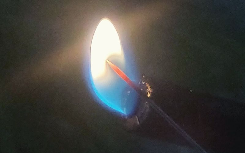 Heating up a needle with a flame