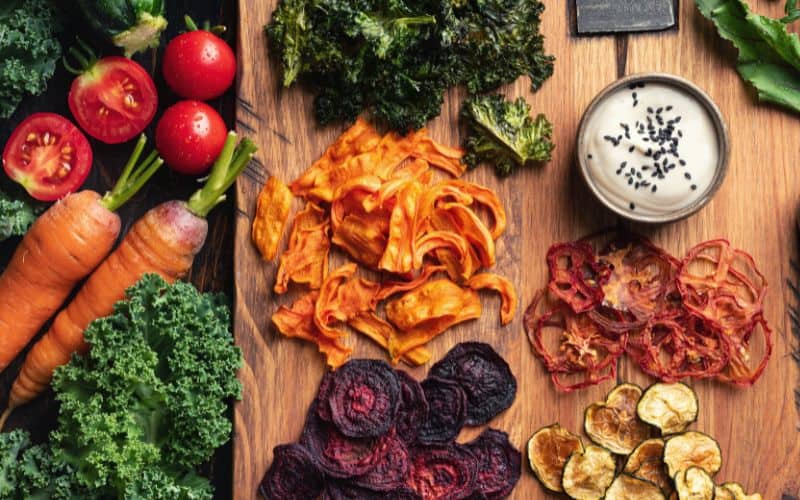 Selection of vegetables and dehydrated veg laid out on a table