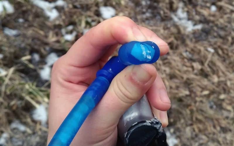 Water frozen in the tube and mouthpiece of a hydration pack's drinking tube 