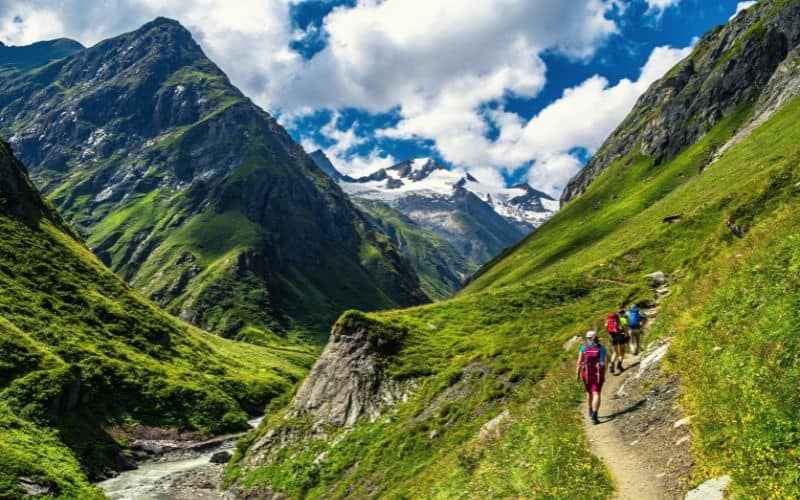 Group of backpackers hiking through Austrian mountains