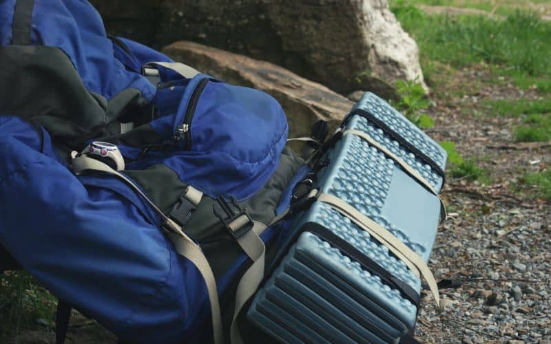 Foldable sleeping pad attached to a backpack