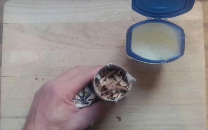 Toilet roll filled with lint, wood shavings, and vaseline 
