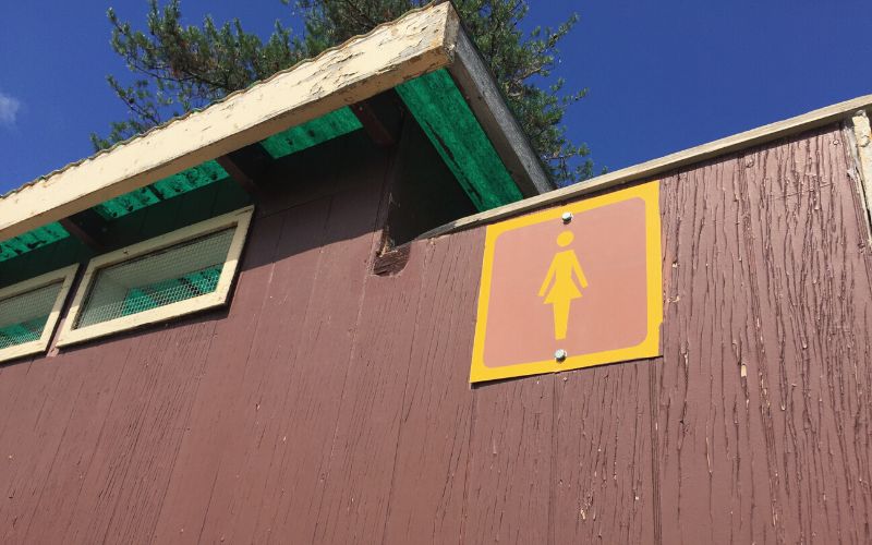 Close up of women's sign on campsite toilet